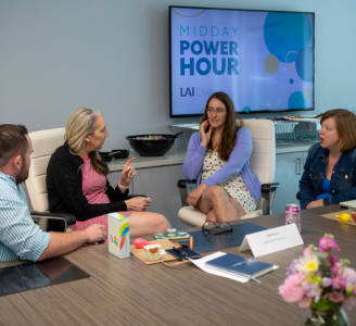 A conference room is pictured with people at a live event