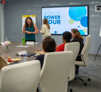 A conference room is pictured with people at a live event